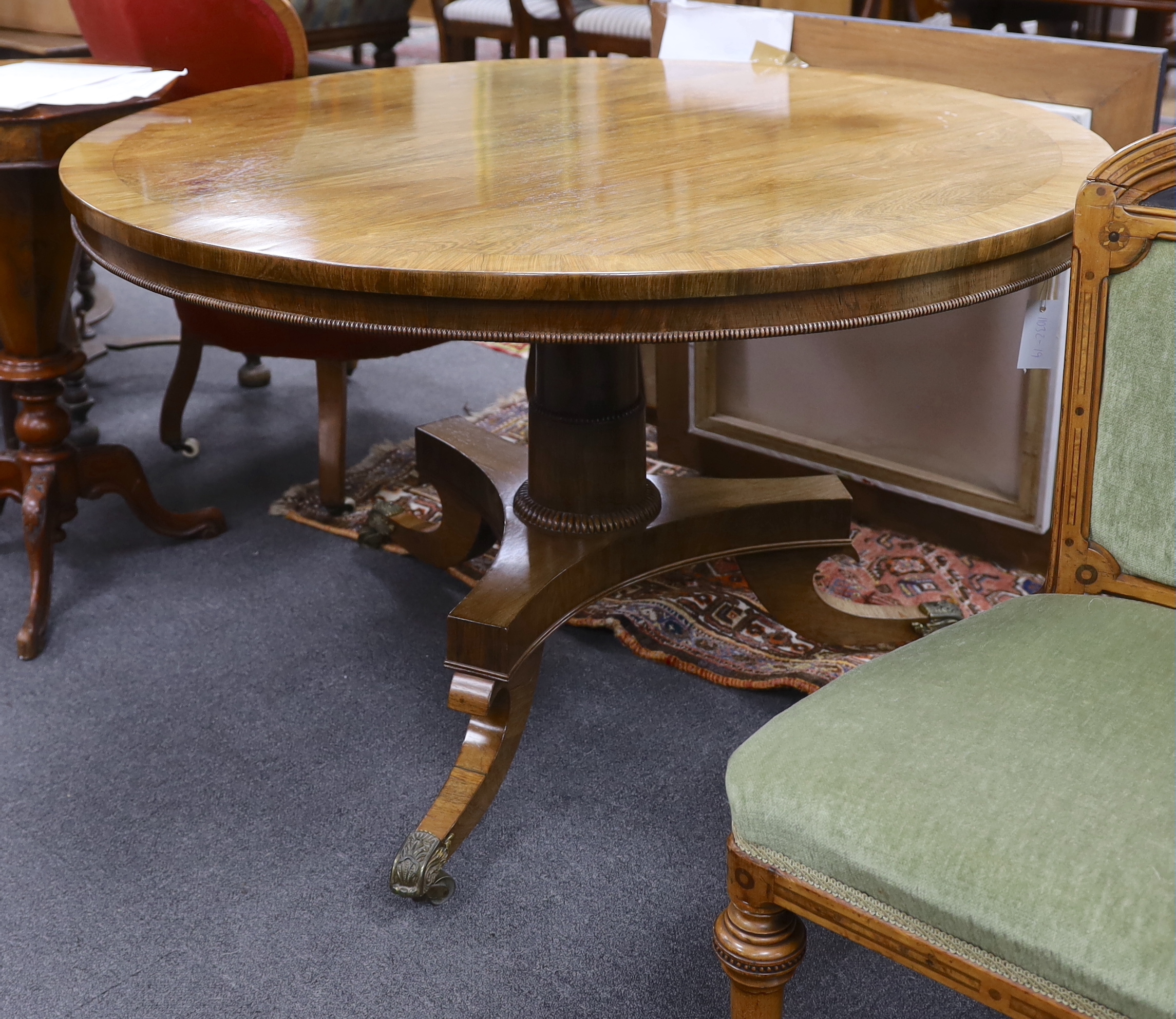 A Regency banded faded rosewood circular tilt top breakfast table, diameter 115cm, height 71cm